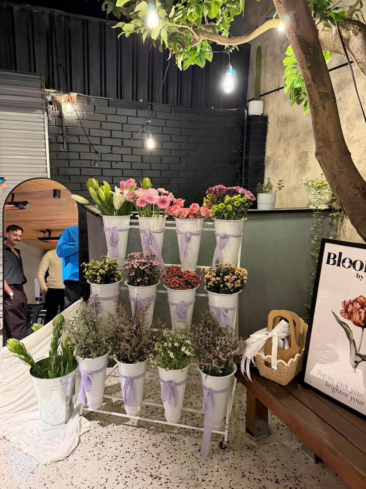 The Bloom Bar stand set up with buckets of seasonal stems