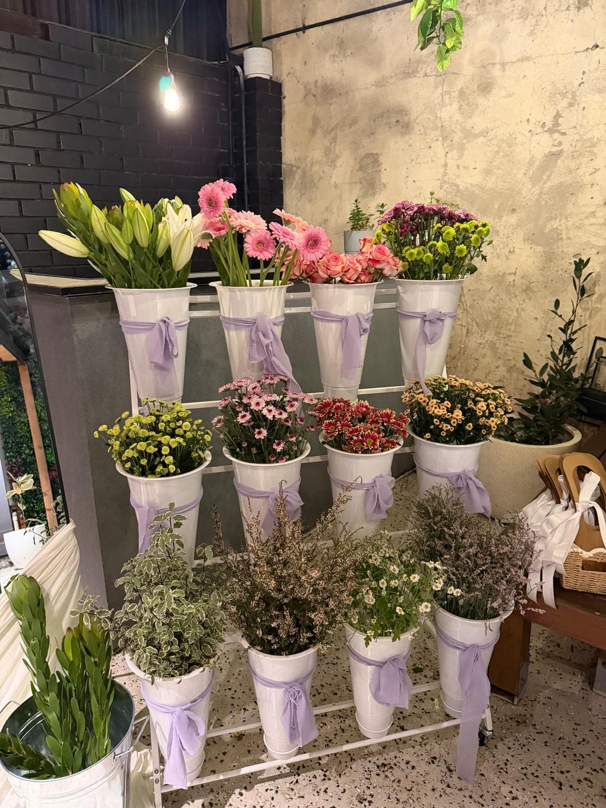 Buckets of seasonal stems on the Bloom Bar stand